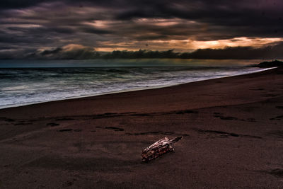 Scenic view of beach against sky during sunset