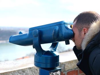 Close-up portrait of man with camera