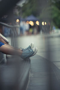 Low section of people sitting on steps