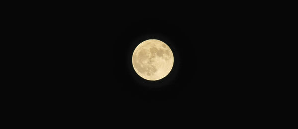 Low angle view of moon against sky at night