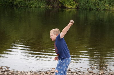Side view of boy standing in lake