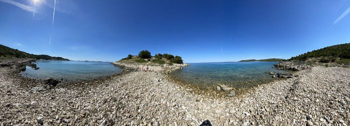 Scenic view of sea against blue sky