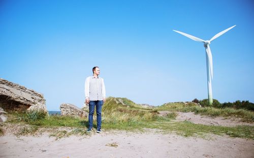 Man standing on field against clear sky