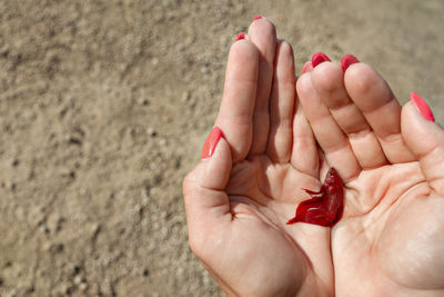 Midsection of woman holding red hands