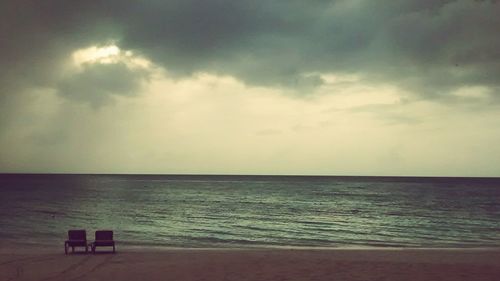 Scenic view of sea against cloudy sky