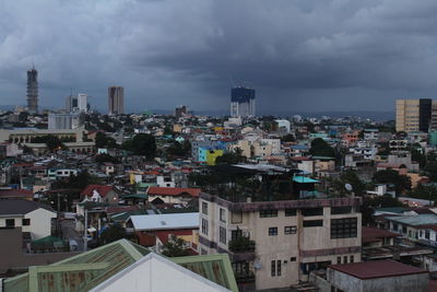 Cityscape against cloudy sky