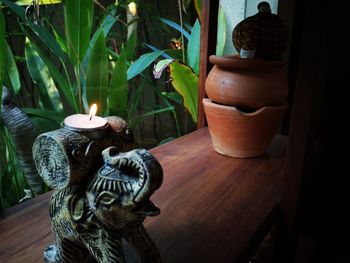 Close-up of illuminated statue on table