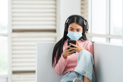 Portrait of young woman using mobile phone