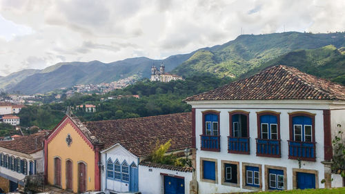 Residential buildings in town against sky