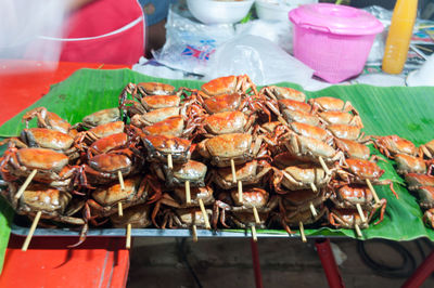 Close-up of cooked crab in tray at table