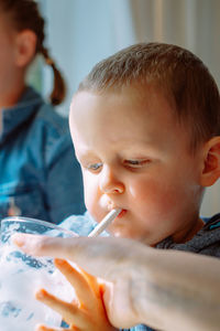 Close-up of cute baby boy drinking shake