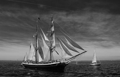 Sailboat sailing in sea against sky