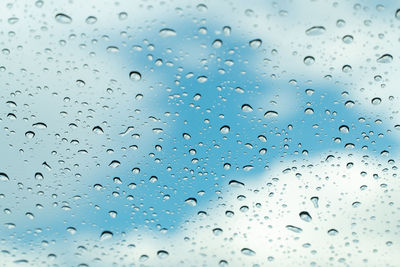 Full frame shot of raindrops on glass window