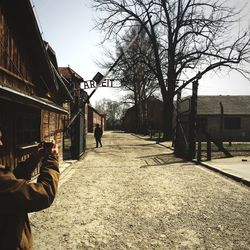 Man photographing auschwitz gate