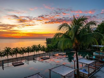 High angle view of pool and beach against sky during sunset