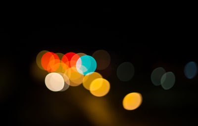 Multi colored lights against black background