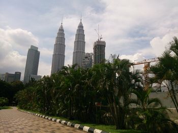 View of skyscrapers against cloudy sky