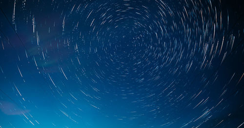 Low angle view of light trails at night