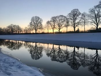 Scenic view of frozen lake against sky during winter