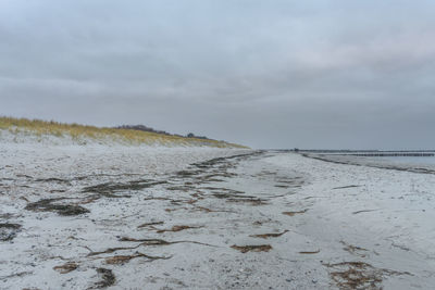 Scenic view of beach against sky during winter
