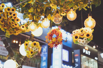 Low angle view of illuminated lanterns hanging from ceiling