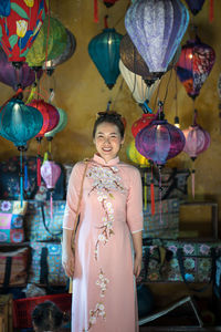 Portrait of woman standing at shop