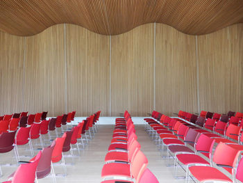 Empty chairs and tables in row