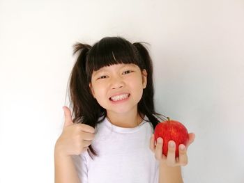 Portrait of happy boy against white background