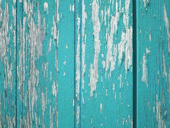 Close-up of weathered turquoise wooden wall