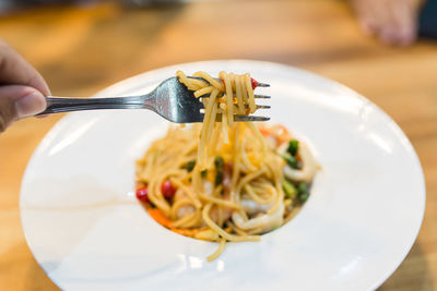 Midsection of person holding ice cream in plate