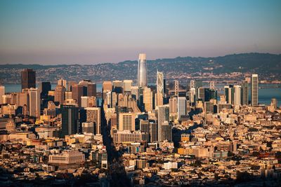 Aerial view of cityscape against sky during sunset