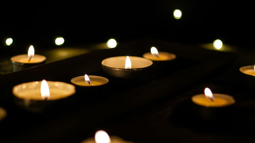 Close-up of illuminated tea light candles