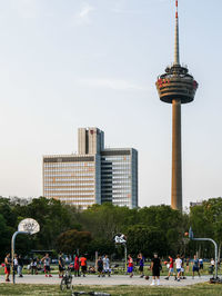 People in front of building against sky