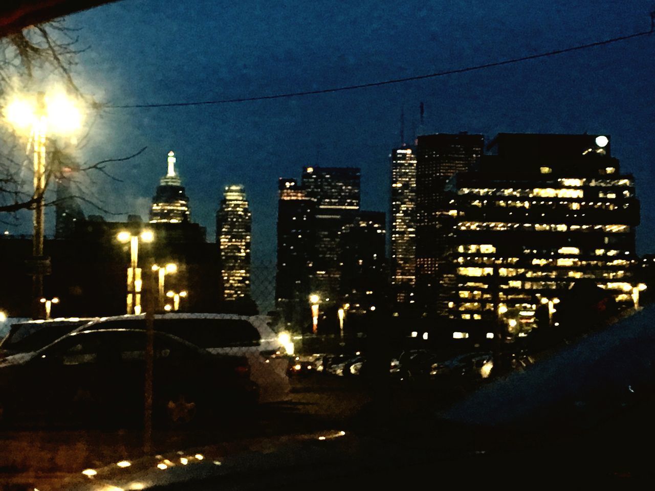 ILLUMINATED MODERN BUILDINGS IN CITY AT NIGHT