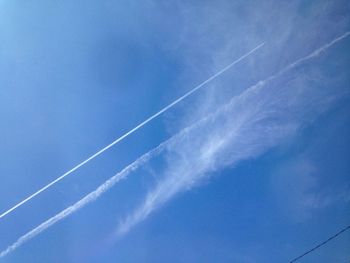 Low angle view of vapor trail in blue sky