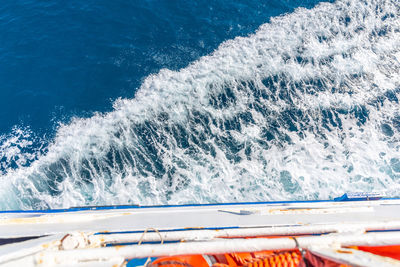 Scenic view of sea waves splashing on boat