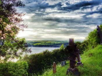 Scenic view of landscape against cloudy sky