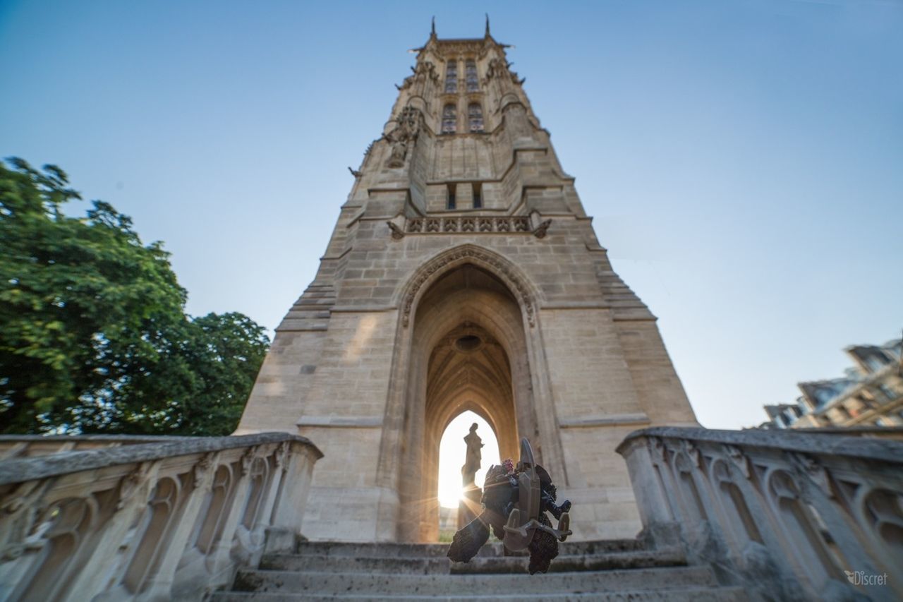 architecture, built structure, building exterior, low angle view, clear sky, arch, history, place of worship, religion, spirituality, statue, tree, sculpture, sunlight, day, famous place, travel destinations