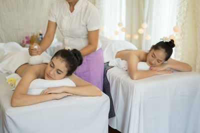 Young woman receiving massage in spa