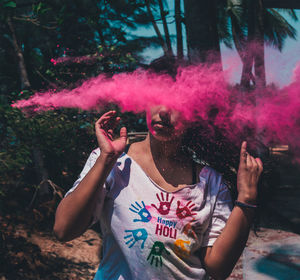 Woman with powder color while standing outdoors