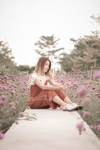 Young woman sitting on field