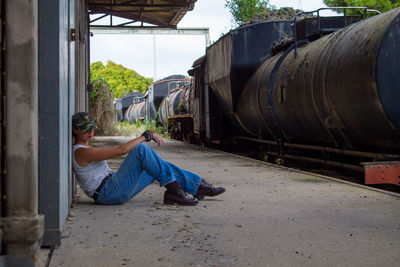 Side view of man working on bus