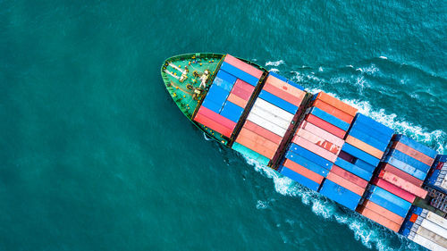 High angle view of cargo containers in ship sailing on sea