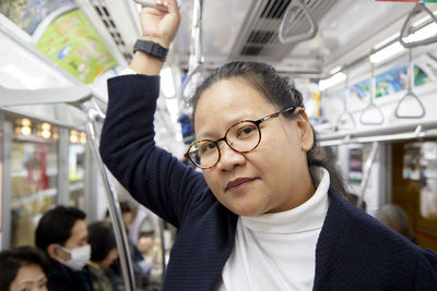 Portrait of mid adult woman in train