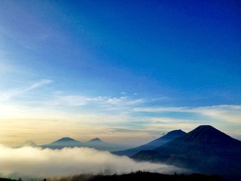 Scenic view of mountains against cloudy sky