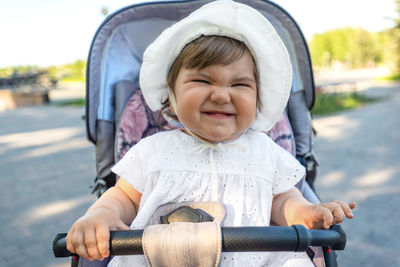 Side view of a smiling girl riding bicycle