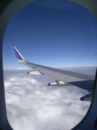 Cropped image of airplane flying over landscape