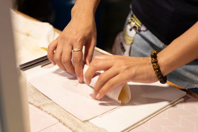 Midsection of woman working on table