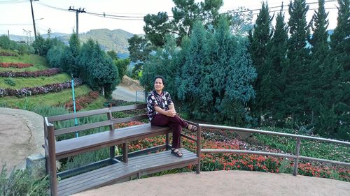 Woman sitting on footbridge