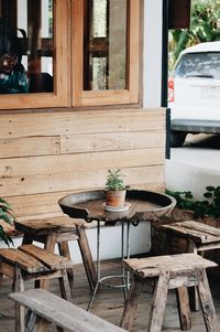 Potted plants on table by window of building